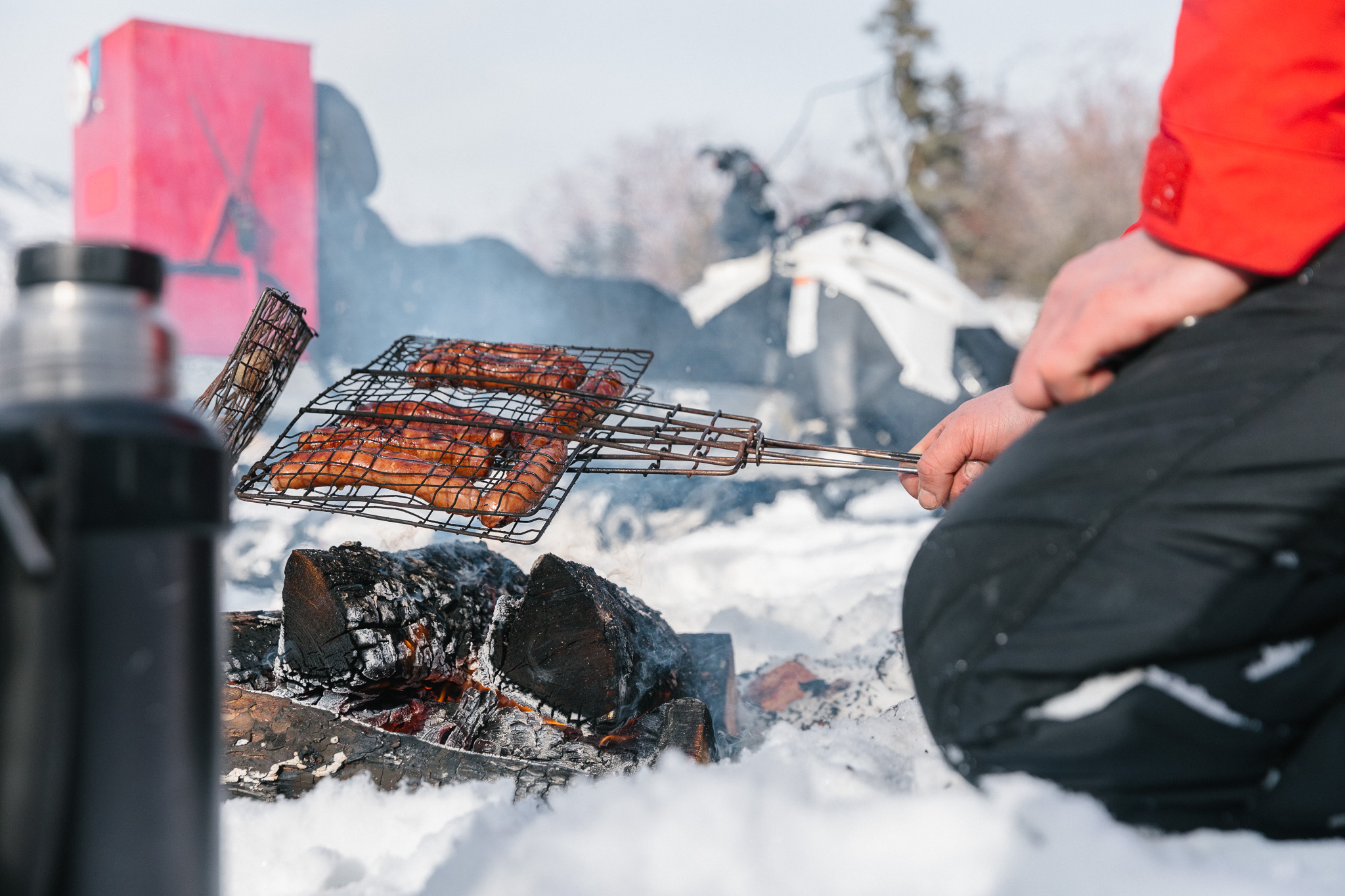 Cooking sausages on a Winter fire